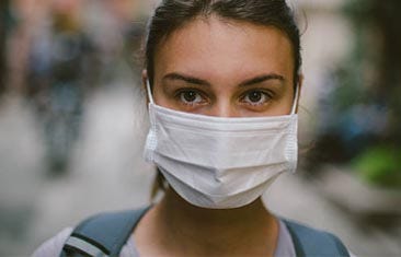 A woman wearing a medical face mask